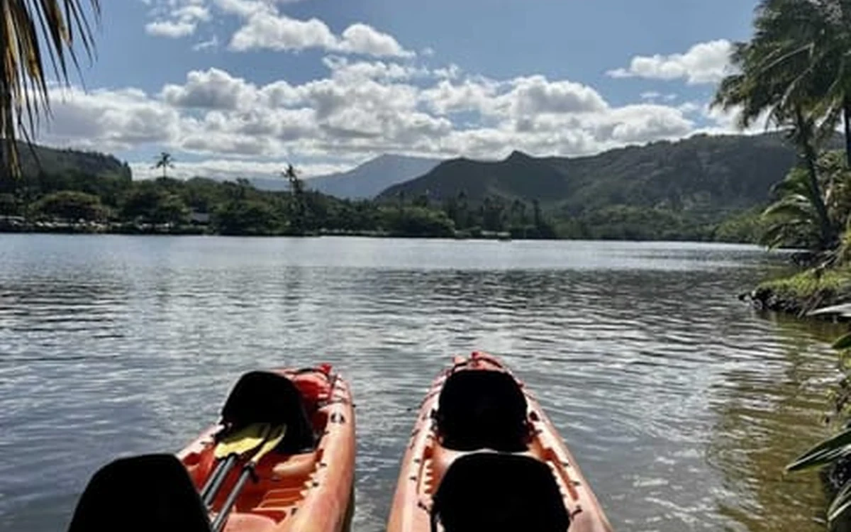 Kayaks on a river on the way to Secret Falls on Kauai